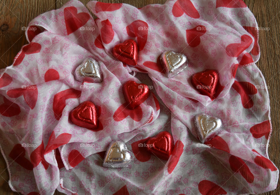 Heart shaped chocolate candy on fabric background