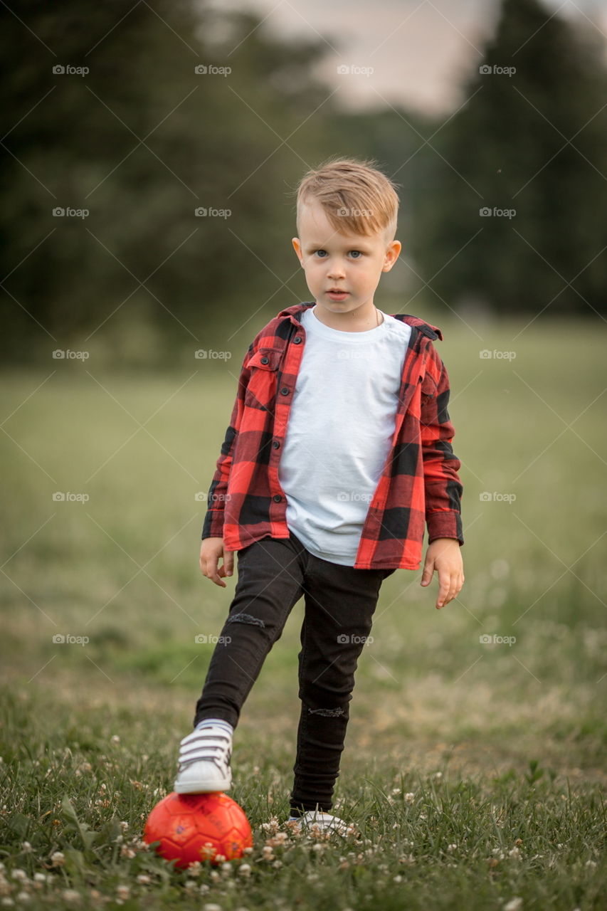 Little boy playing in soccer in a park 