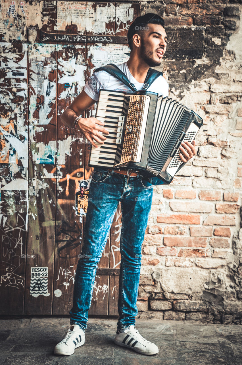 Young Man Accordion Music Player Performing In The Street
