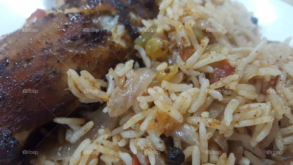 Closer look of a dish of Chicken Mandi or Roasted Chicken with rice, made with special light tasty spices and of course.. love and care :) This food is mostly cooked in remote area of saudi deserts by oldies. visit us to have a bite of this Mandi :)