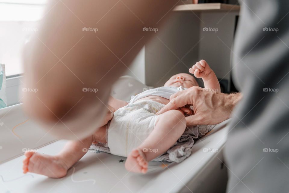 Close-up shot of father changing baby's diaper