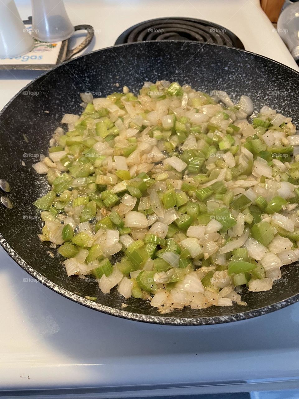 Onions, green peppers, celery, and garlic sauté 