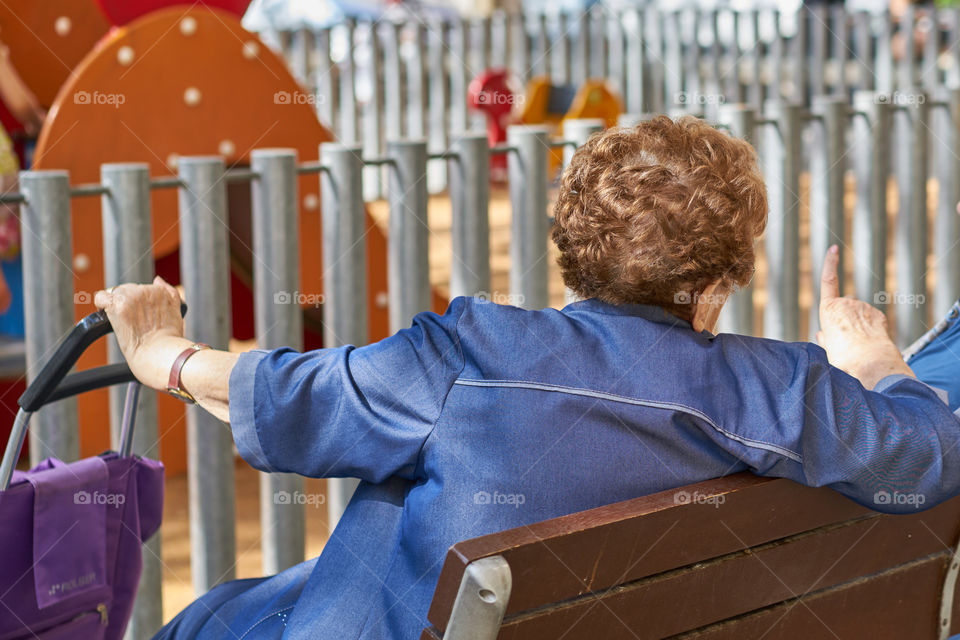 Elderly woman talking with a friend at a square