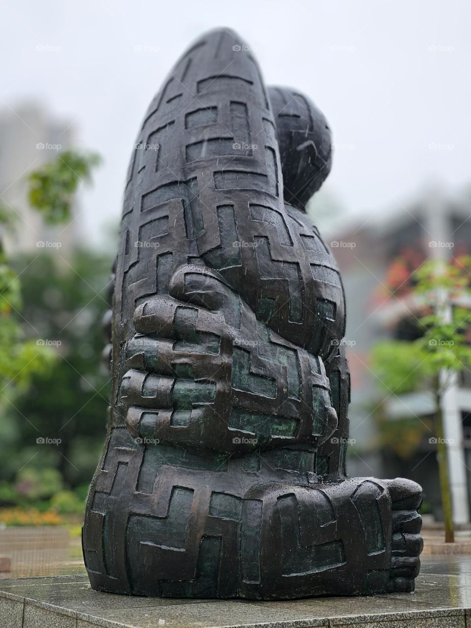 Hugging self bronze statue