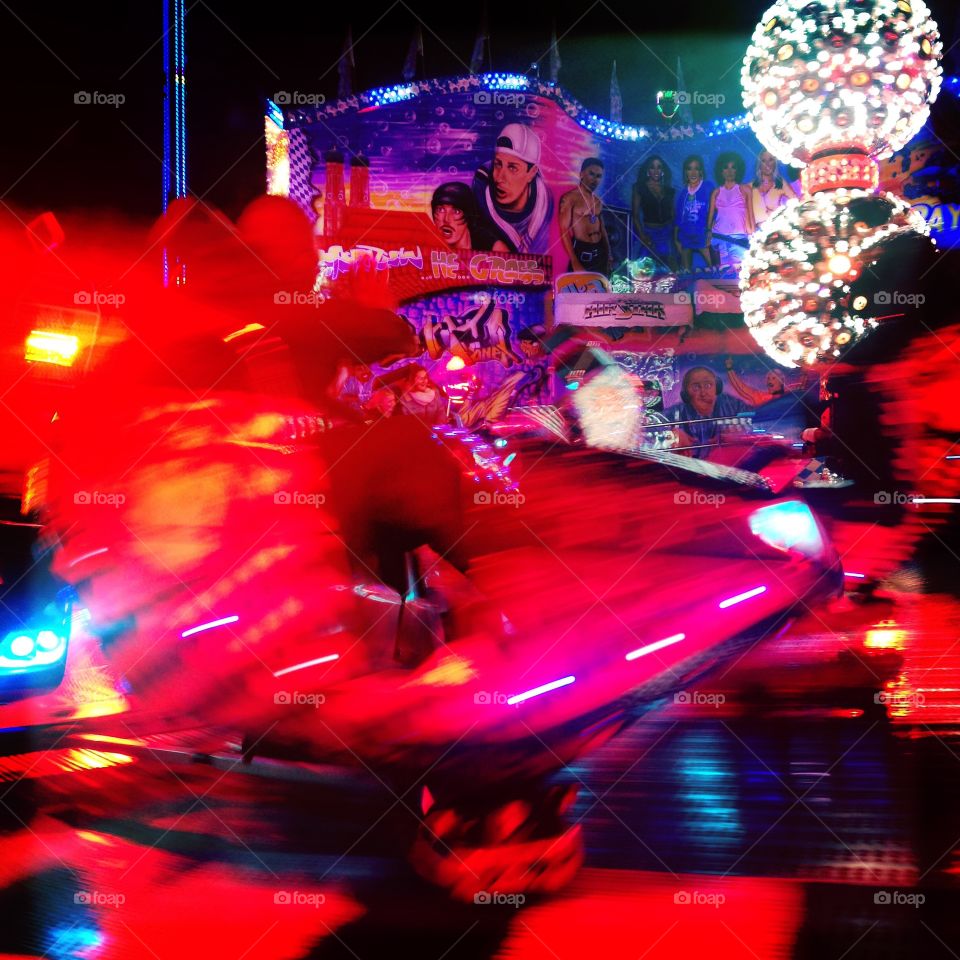 Red fairground ride and lights moving movement