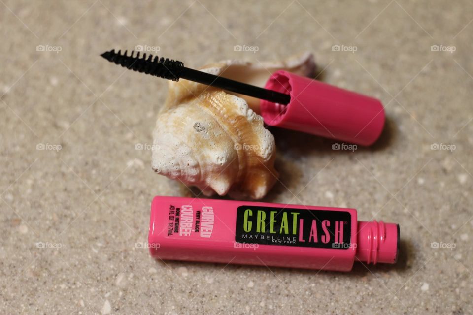 Maybelline Great Lash mascara pink container open showing brush resting on seashell top view