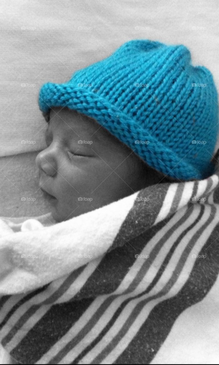 Infants first hat. Baby just out the womb with his first blue hat 