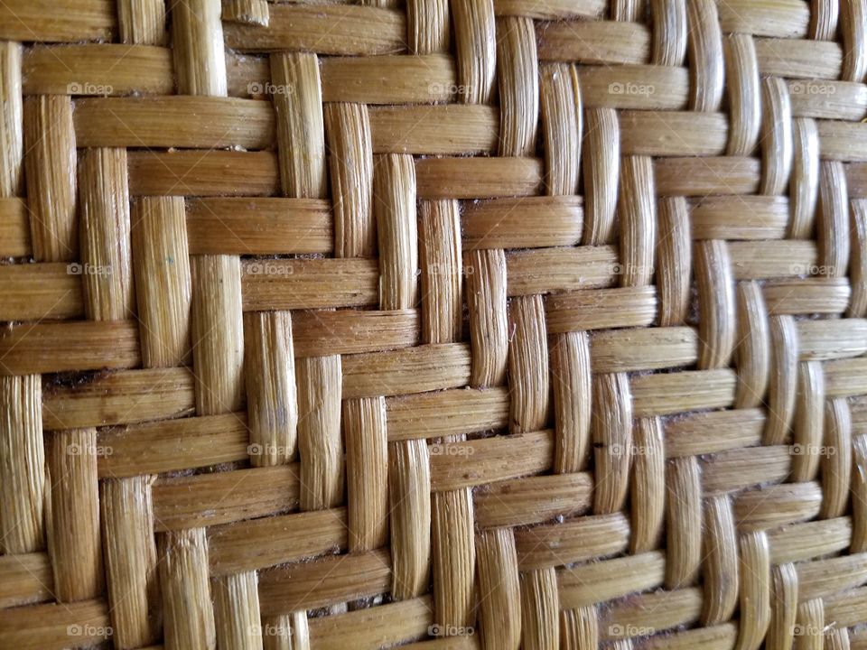 woven wicker pattern multi-directional with multi brown tones. natural wood in woven pattern.