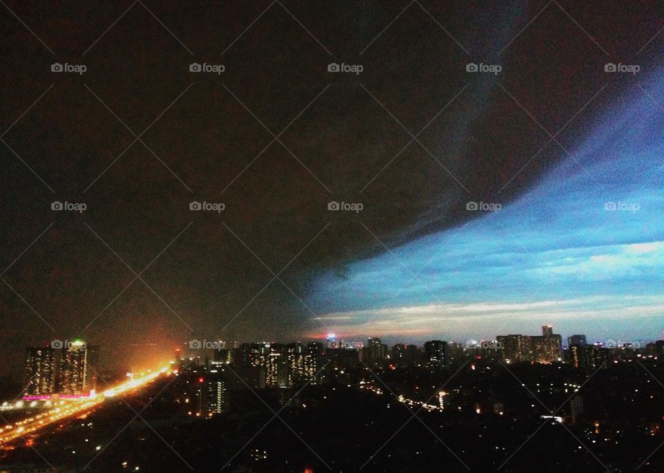 The sky before the storm with dark clouds and the other side is still bright. “Clouds, they make a painting out of the sky.” That’s right.