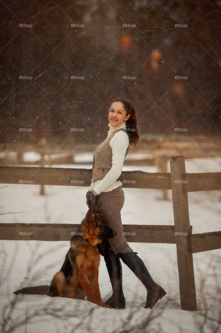 Young beautiful woman with German shepherd dog outdoor portrait at spring day