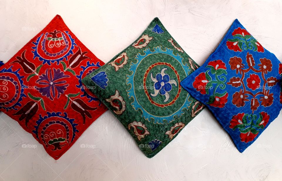 Handmade pillows on white background