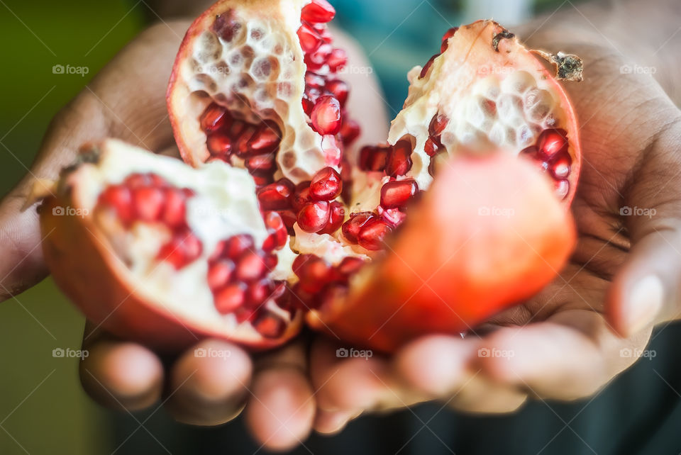 A pomegranate slice on hand