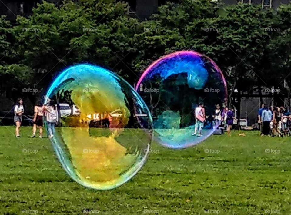 Clash of colors: big bubbles in the park. rainbow color.
