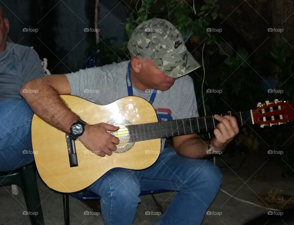 A moment in our personal space, playing the guitar, a very beautiful musical instrument and a spectacular sound