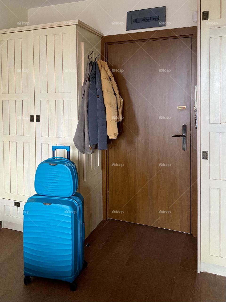 Blue suitcases in front of door 