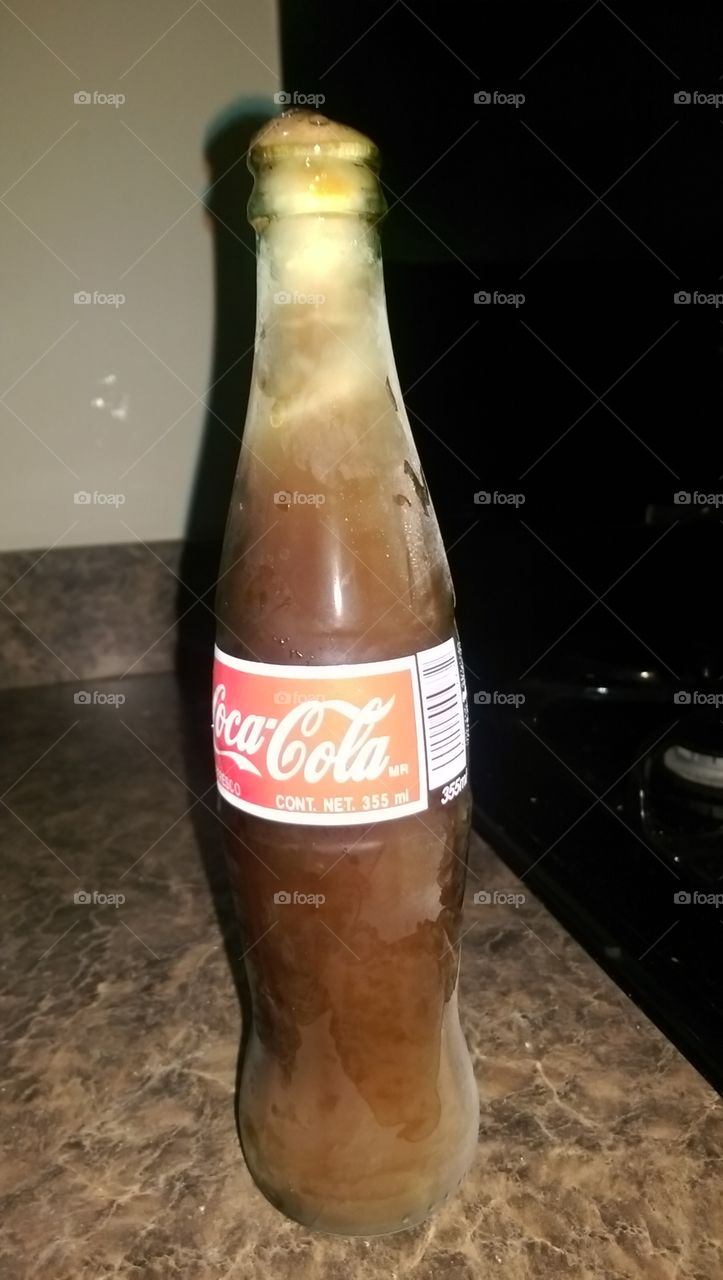 A bottle of Mexican Coke left accidentally in the freezer.
