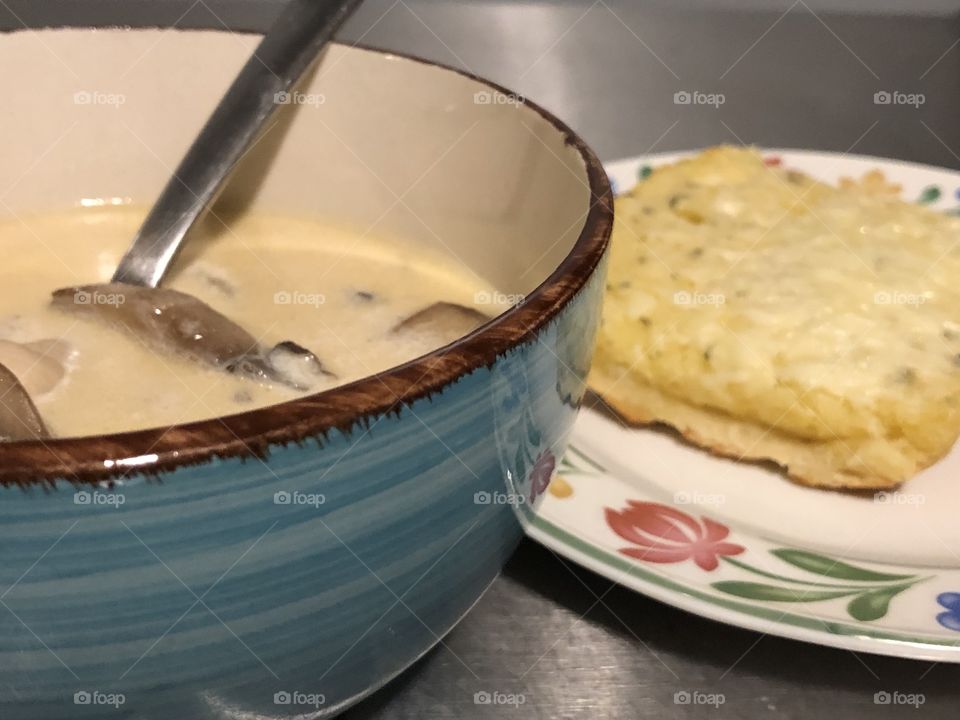 Warm chicken mushroom soup with hot cheesy garlic bread