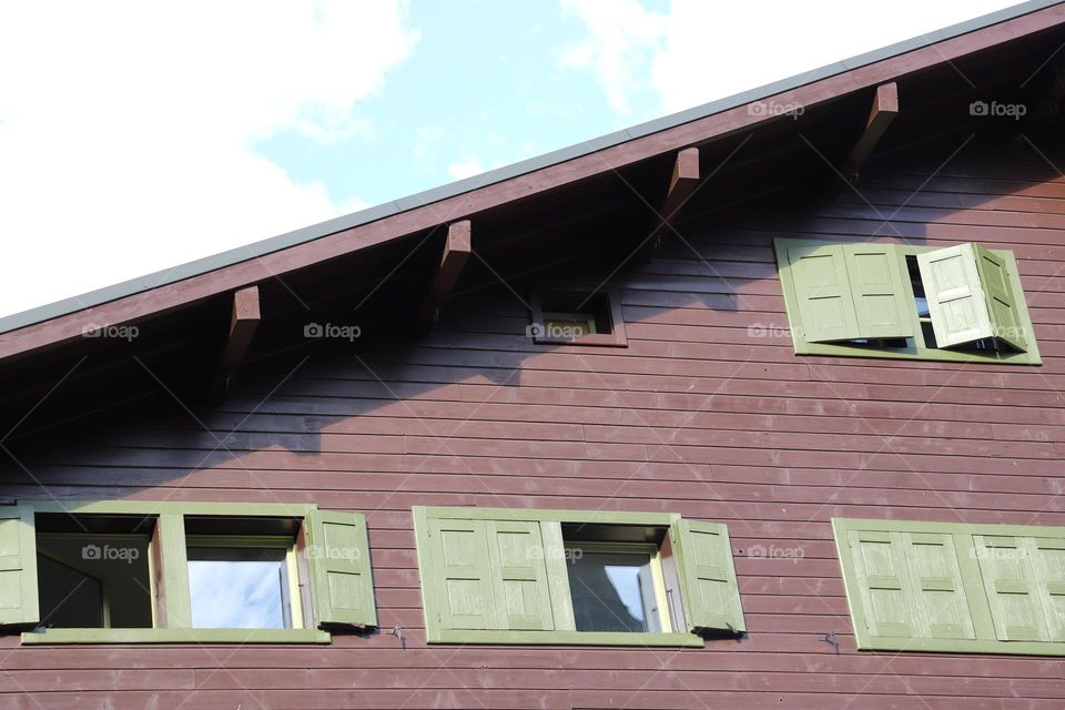 brown building with green windows 