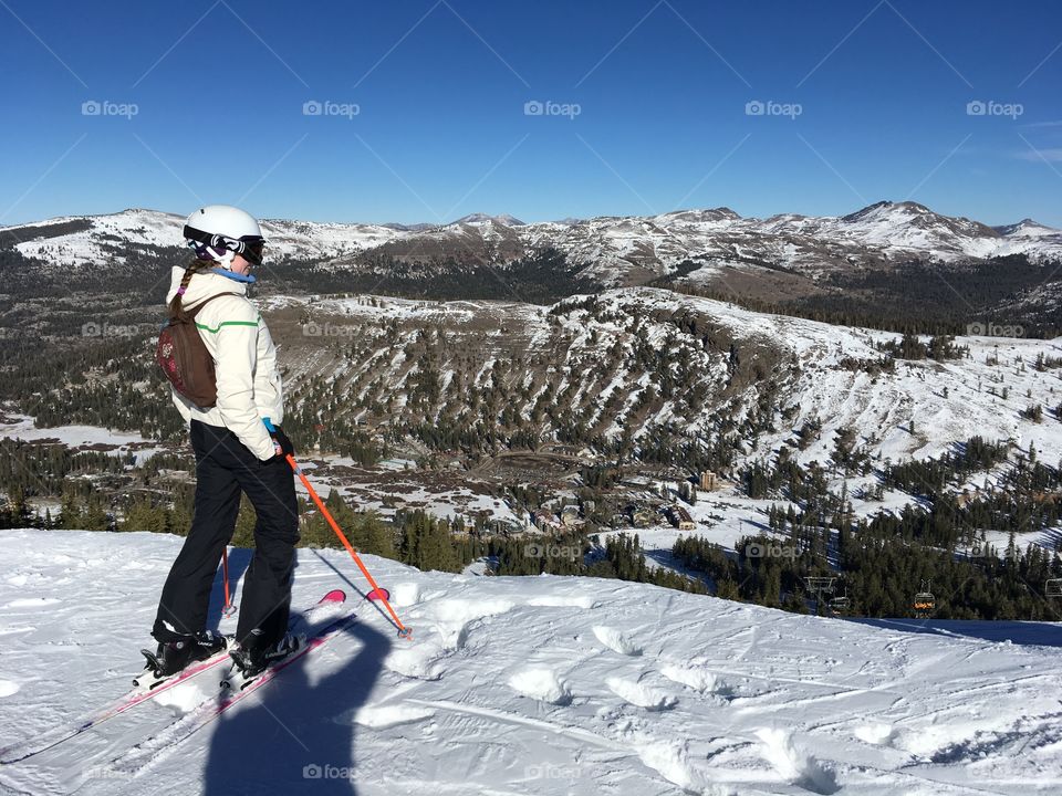 Woman skier at the top of a snow covered mountain