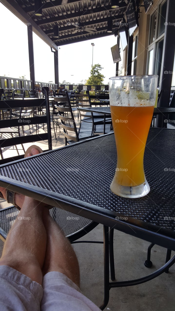 relaxing. relaxing in the patio,  enjoying a cold beer