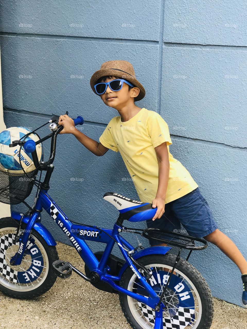 A boy with blue by cycle and blue football and wearing blue spectacle 😍