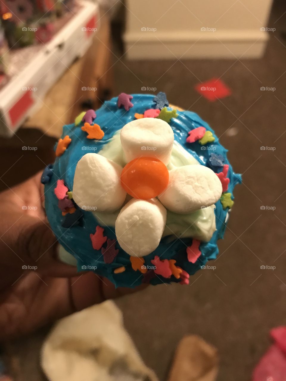 Candy decorated cupcake with blue icing and marshmallows 