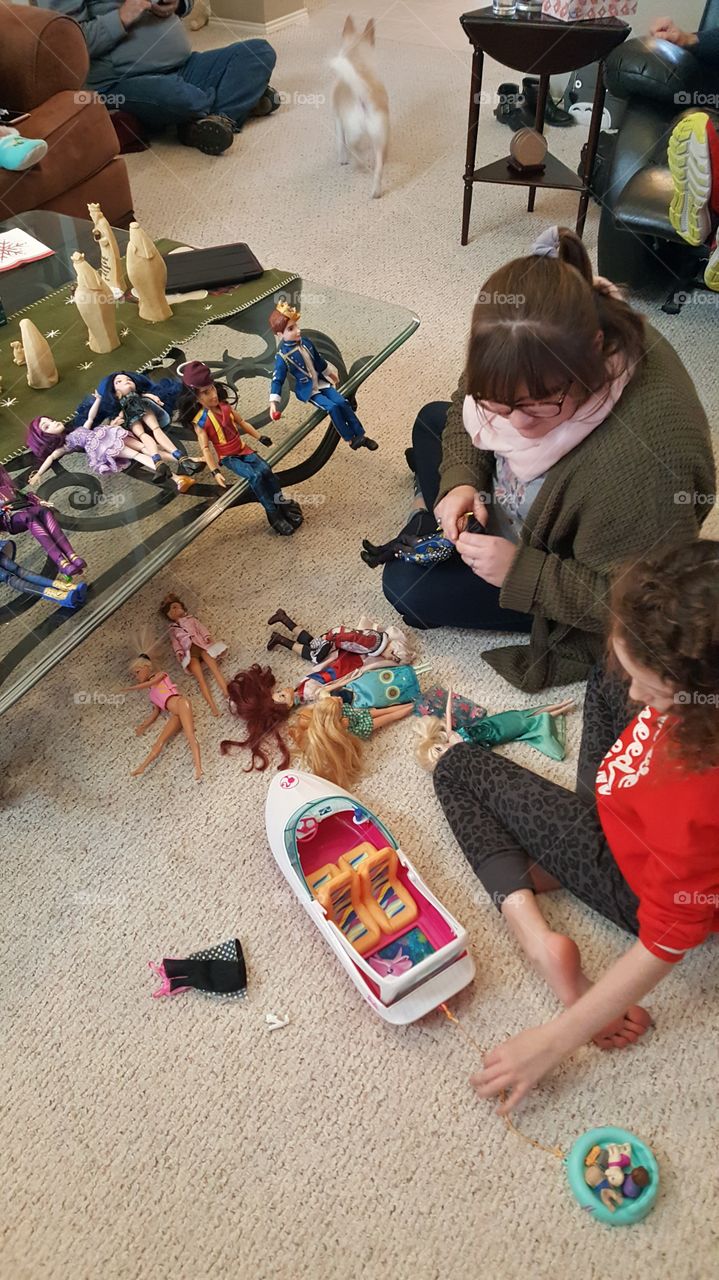 Cousins playing with dolls
