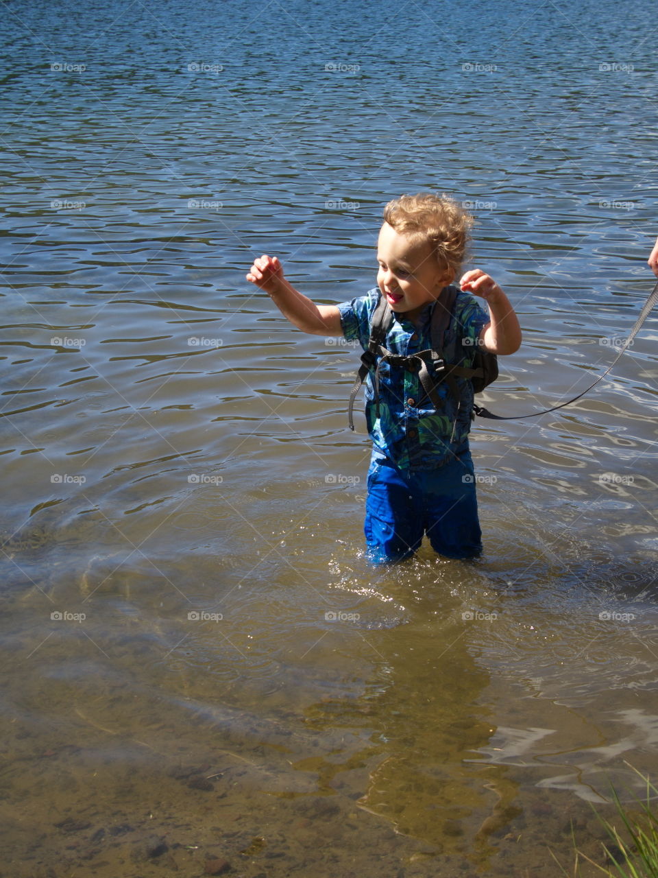 Little boy on summer vacation at high lake in Oregon forest 