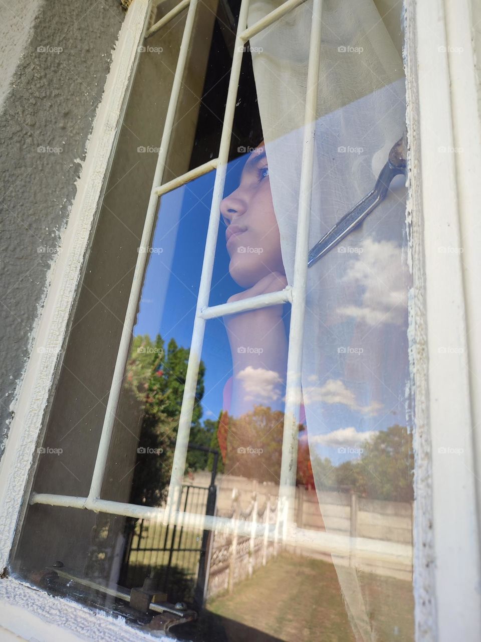 Young male looking out of the window