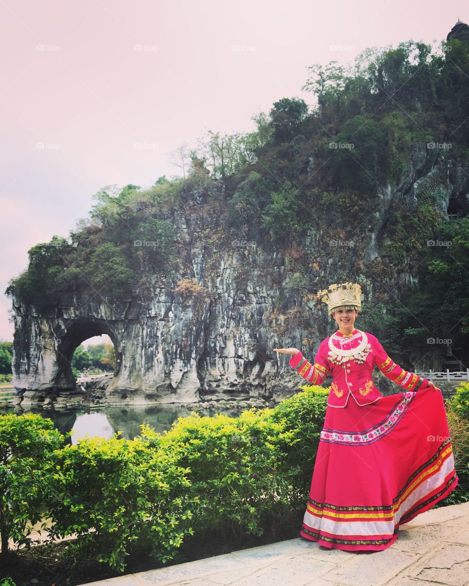 Asian woman posing outdoors wearing traditional cloths