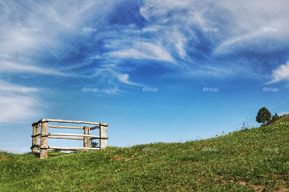 Wooden fence around a water well on the mountain top 