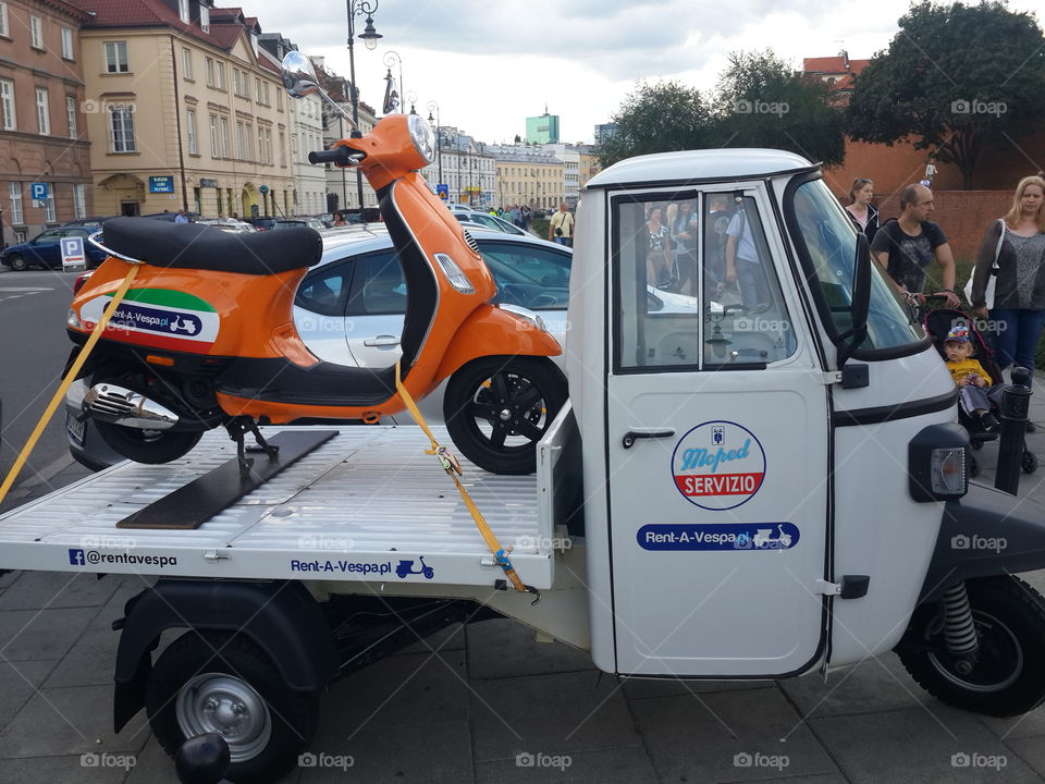 big scooter driven small scooter. Warsaw Poland