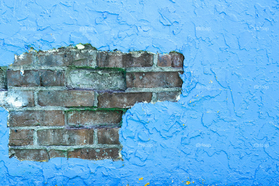 Exposed brick on a brightly painted wall