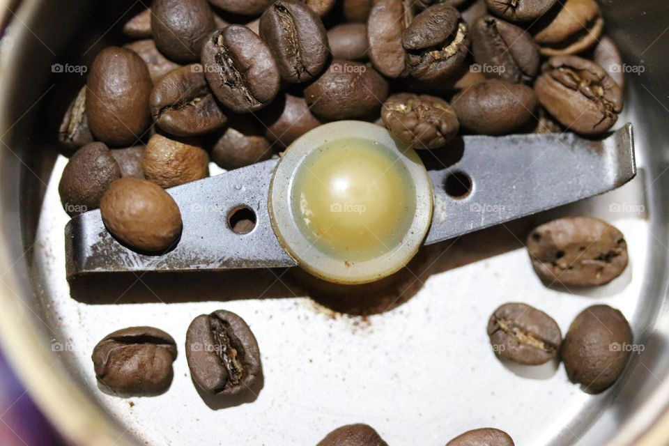 coffee beans in a coffee grinder