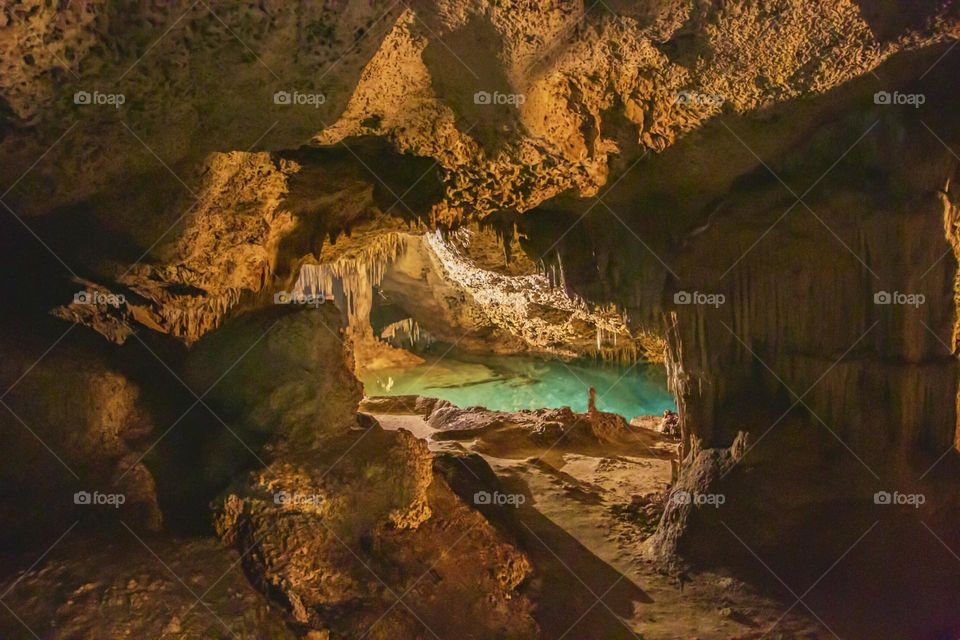 underground cenote with stalactites and stalactites and crystal clear waters