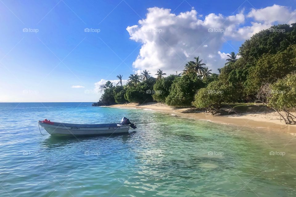 boat in the water near the beach of the tropical ocean