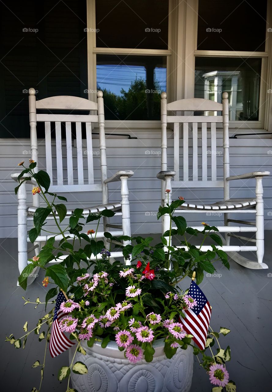 Rocking chairs set in a shaded porch 