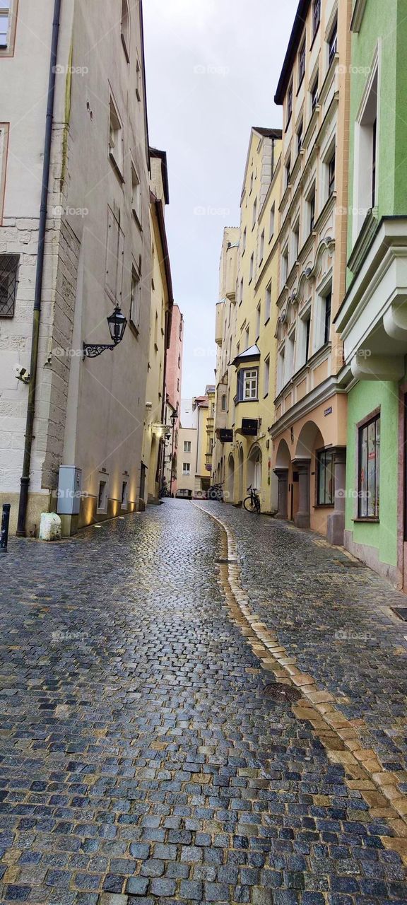 A narrow alley covered entirely with cobble stone in the beautiful city of “Regensburg”, capitol of the “Oberpfalz” which is located just north of the state of “Bavaria” in “Germany”. 2023. Hypnotic Productions
