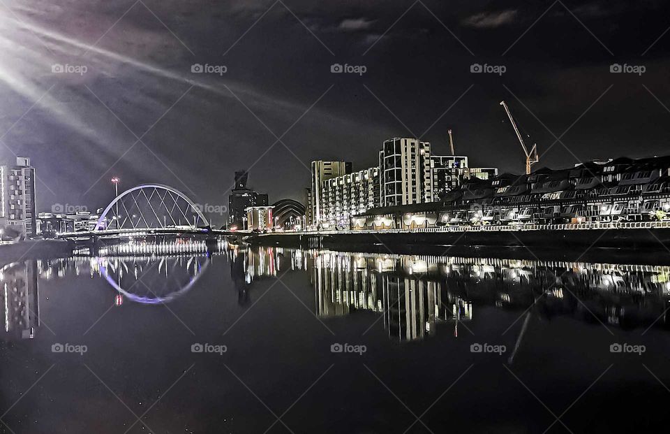 A stunning circle of light from the Clyde Arc bridge element and its reflections in the Clyde River. This 96_meter bridge was put i to use in 2006 and crosses the River at an angle so that users passing it are constantly in the bend.