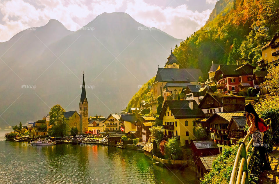 Woman standing near famous Hallstatt lakeside town