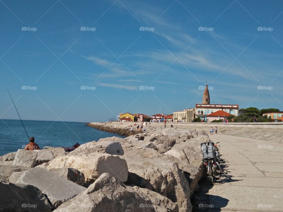 a panoramic view of sea horizon from caorle venice italy city seafront rock