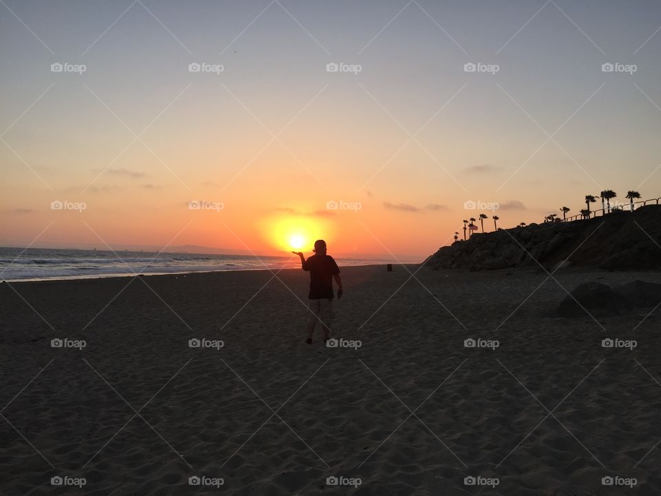 Sun in my Hand. Sunset Huntington Beach