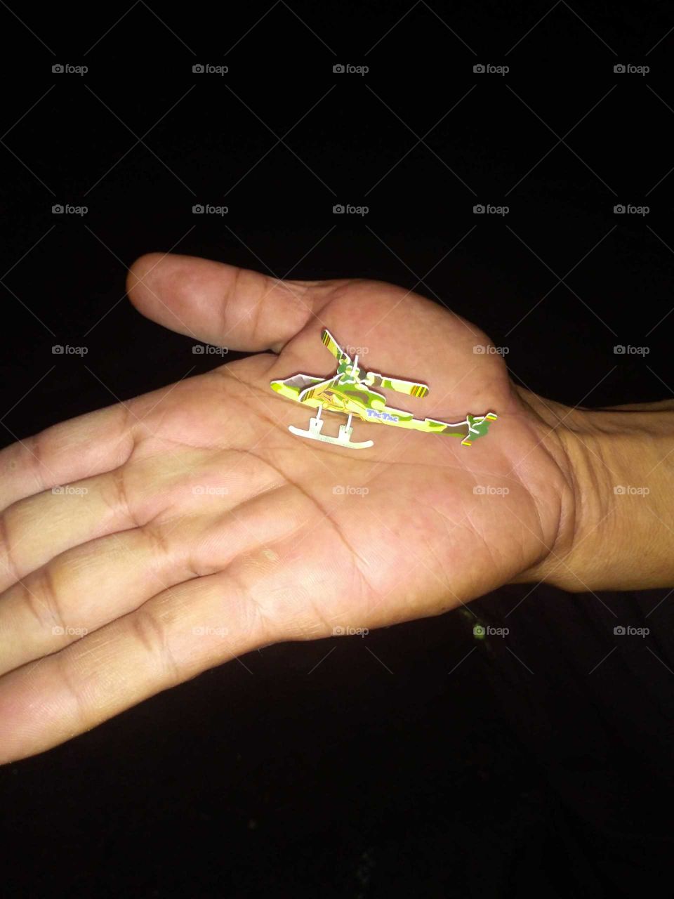 small helicopter toy in hand