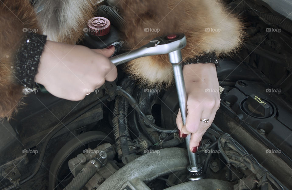 the girl is repairing the car