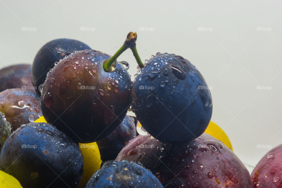 Fresh fruits plums with drops water