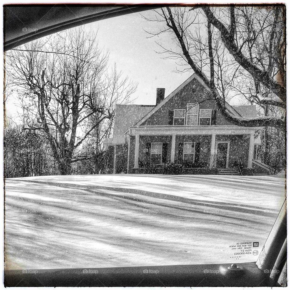 black and white old home in wintery weather