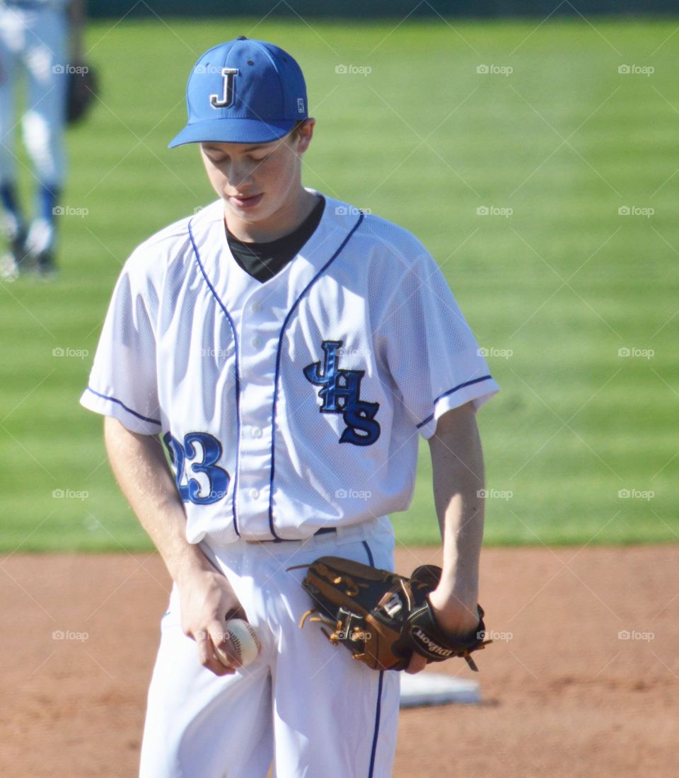 Portrait of a teenager baseball player in a field