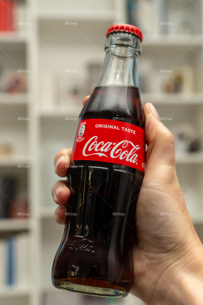 bottle of Coke in a hand
