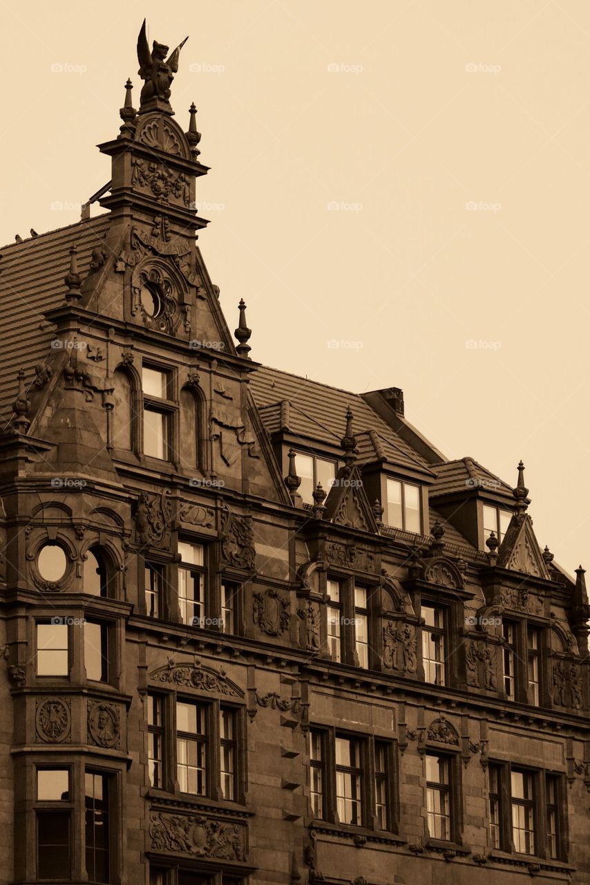 old building in berlin city with demon on roof in brown finish
