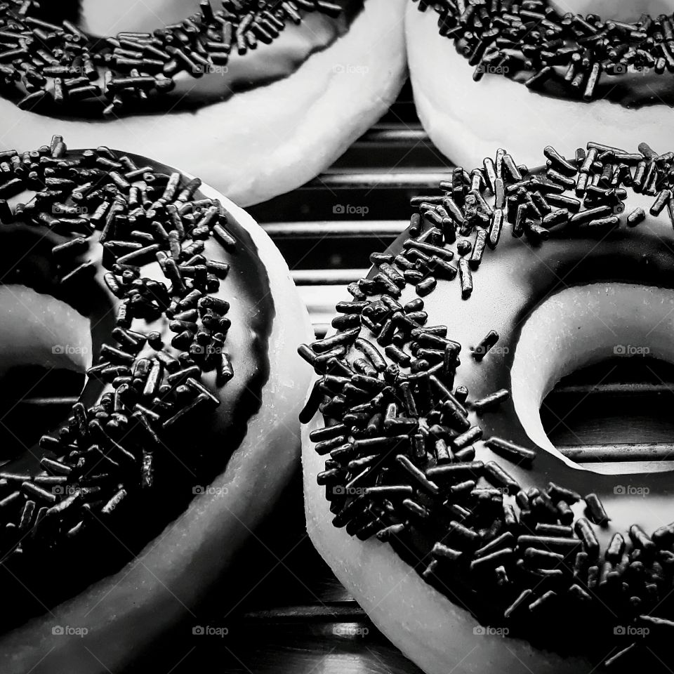 Chocolate covered donuts in black and white